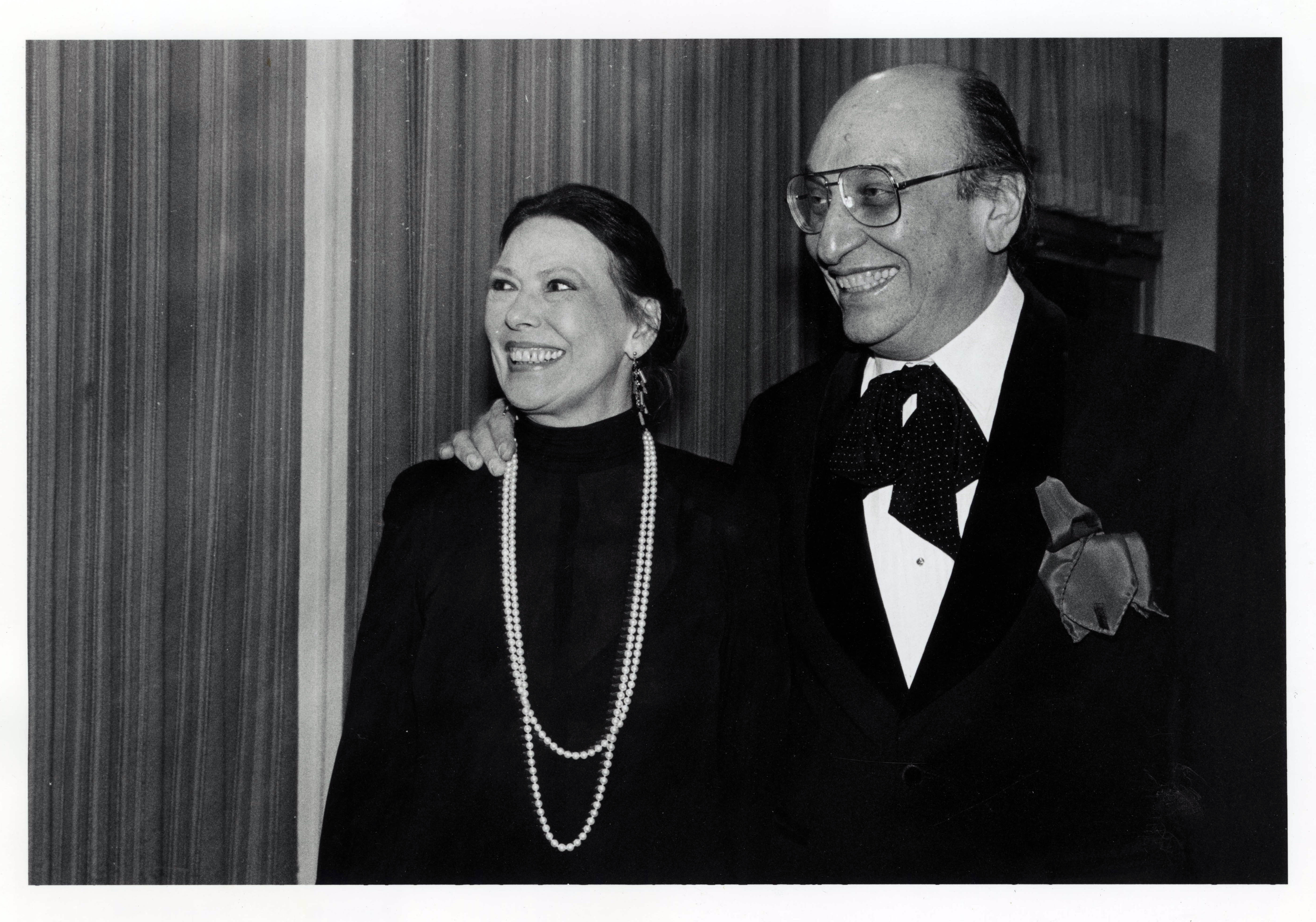 woman with pearls and a man with glasses